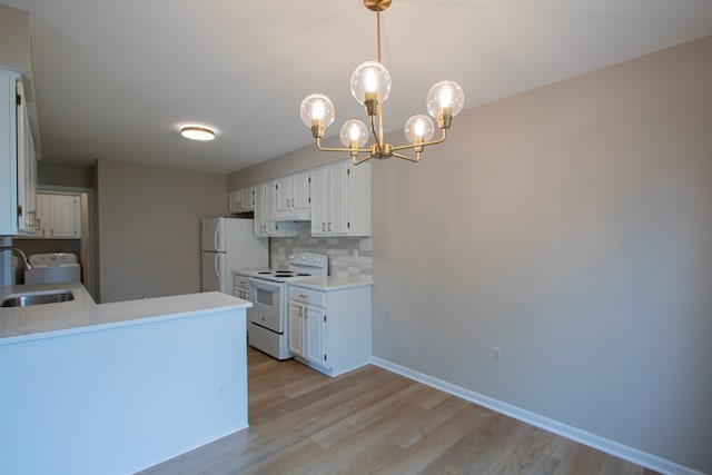 37374 Stonegate Cir, Clinton Township, MI 48036 - kitchen with white appliances, a sink, decorative backsplash, and light wood-style floors