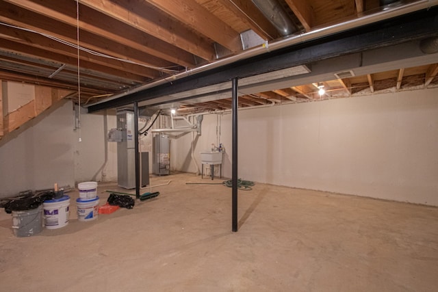 37374 Stonegate Cir, Clinton Township, MI 48036 - unfinished basement featuring gas water heater, a sink, and heating unit