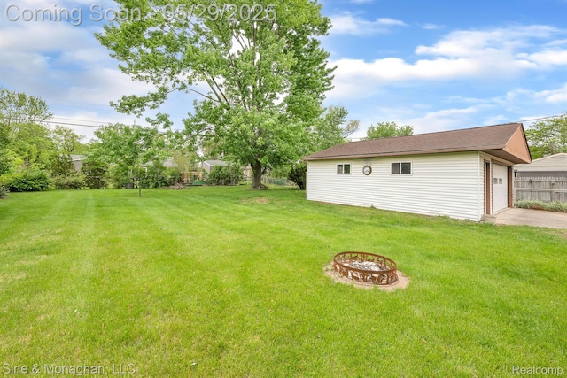 2514 Hearthside Dr, Ypsilanti, MI 48198 - view of yard featuring a fire pit, an outdoor structure, and concrete driveway