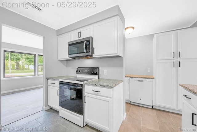 2514 Hearthside Dr, Ypsilanti, MI 48198 - kitchen with stainless steel microwave, electric stove, and white cabinets