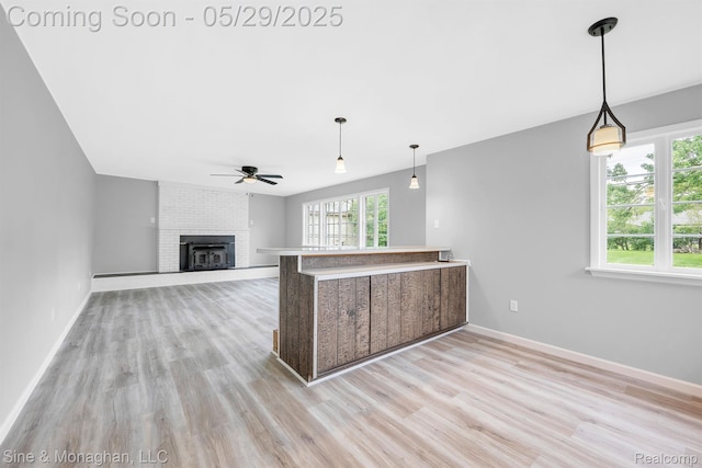 2514 Hearthside Dr, Ypsilanti, MI 48198 - kitchen with ceiling fan, wood finished floors, a brick fireplace, and baseboards