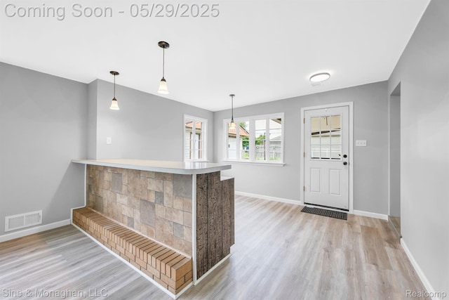 2514 Hearthside Dr, Ypsilanti, MI 48198 - kitchen with light wood-type flooring, baseboards, and hanging light fixtures