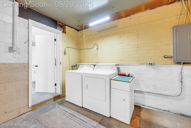 2514 Hearthside Dr, Ypsilanti, MI 48198 - washroom featuring electric panel, concrete block wall, cabinet space, and separate washer and dryer