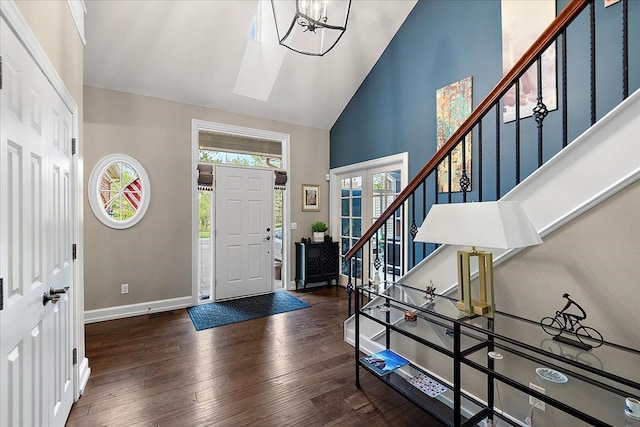 4735 Oakhurst Ridge Rd, Clarkston, MI 48348 - foyer entrance featuring high vaulted ceiling, stairway, baseboards, hardwood / wood-style flooring, and a chandelier