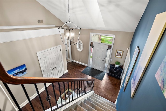4735 Oakhurst Ridge Rd, Clarkston, MI 48348 - entrance foyer featuring vaulted ceiling, a chandelier, dark wood finished floors, stairs, and baseboards