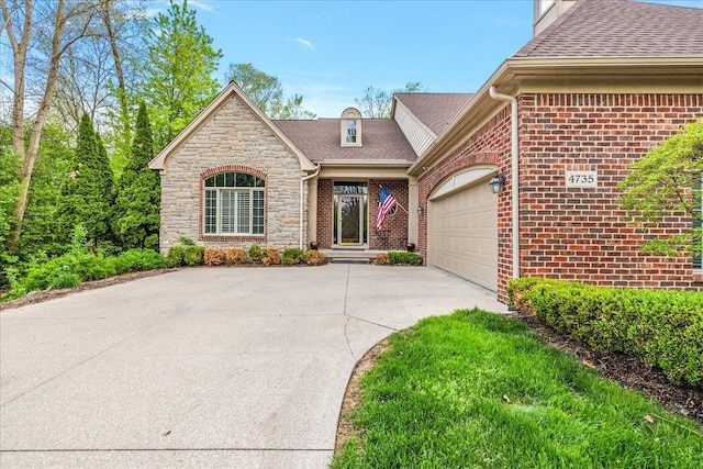 4735 Oakhurst Ridge Rd, Clarkston, MI 48348 - view of front of home with driveway, a garage, brick siding, and a shingled roof