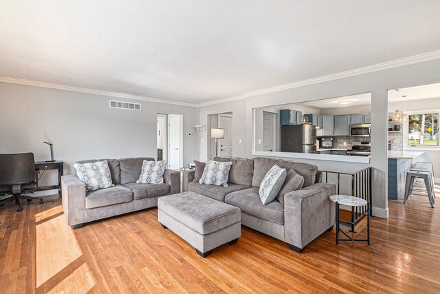 926 Brighton Lake Rd, Brighton, MI 48116 - living room featuring light wood-style floors and ornamental molding