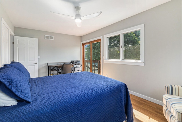 926 Brighton Lake Rd, Brighton, MI 48116 - bedroom featuring baseboards, wood finished floors, access to exterior, ceiling fan, and radiator
