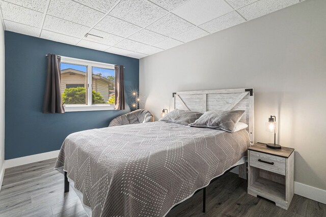 926 Brighton Lake Rd, Brighton, MI 48116 - bedroom with baseboards, a drop ceiling, and wood finished floors