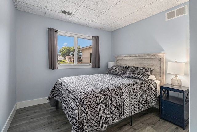 926 Brighton Lake Rd, Brighton, MI 48116 - bedroom featuring a paneled ceiling, wood finished floors, and baseboards