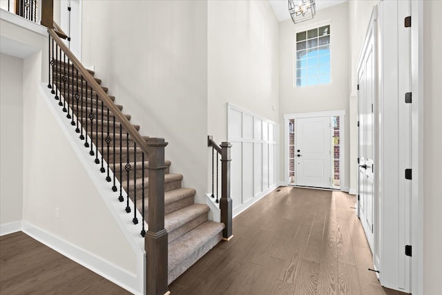 2080 Crested Butte Dr, White Lake, MI 48383 - foyer with wood finished floors, stairway, a high ceiling, and baseboards