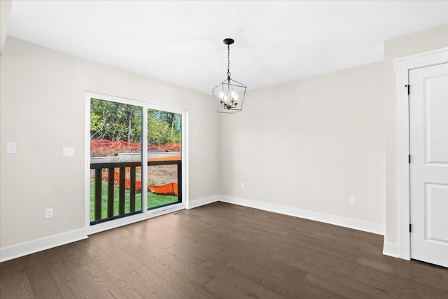 2080 Crested Butte Dr, White Lake, MI 48383 - empty room featuring a chandelier, dark wood-type flooring, and baseboards