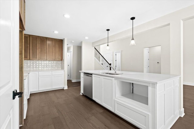 2080 Crested Butte Dr, White Lake, MI 48383 - kitchen with stainless steel dishwasher, a sink, dark wood finished floors, decorative backsplash, and light countertops