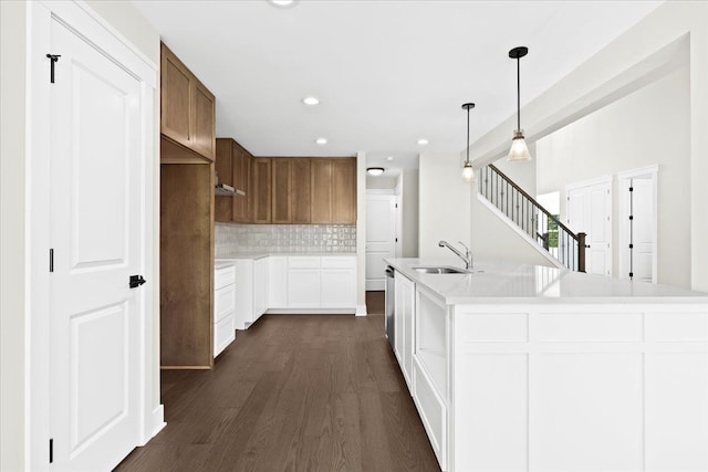 2080 Crested Butte Dr, White Lake, MI 48383 - kitchen featuring a sink, dark wood-style flooring, backsplash, recessed lighting, and light countertops