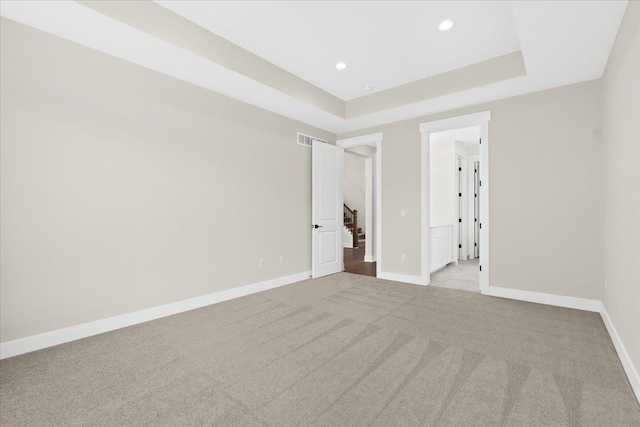 2080 Crested Butte Dr, White Lake, MI 48383 - unfurnished room with light carpet, baseboards, a raised ceiling, recessed lighting, and stairway
