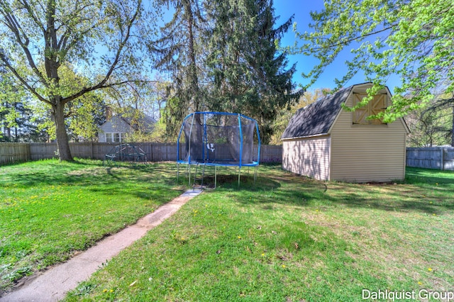 1573 N Whitehall Rd, Muskegon, MI 49445 - view of yard featuring a trampoline, a storage unit, and an outbuilding