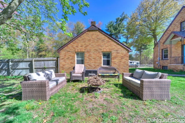 1573 N Whitehall Rd, Muskegon, MI 49445 - rear view of property with an outdoor living space, fence, a chimney, and brick siding