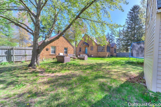 1573 N Whitehall Rd, Muskegon, MI 49445 - view of yard featuring a trampoline and an outdoor hangout area
