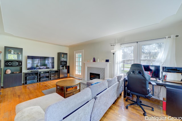 1573 N Whitehall Rd, Muskegon, MI 49445 - living area featuring a desk, wood finished floors, and a fireplace with flush hearth