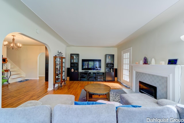 1573 N Whitehall Rd, Muskegon, MI 49445 - living area featuring arched walkways, wood finished floors, stairs, and baseboards
