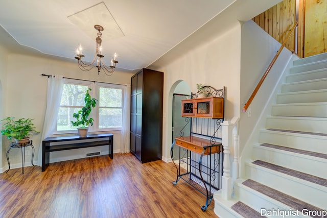 1573 N Whitehall Rd, Muskegon, MI 49445 - entryway featuring a chandelier, stairway, wood finished floors, arched walkways, and baseboards