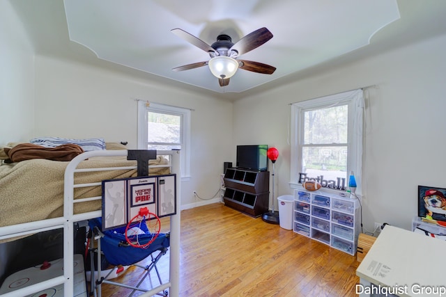 1573 N Whitehall Rd, Muskegon, MI 49445 - bedroom with light wood-style floors and ceiling fan
