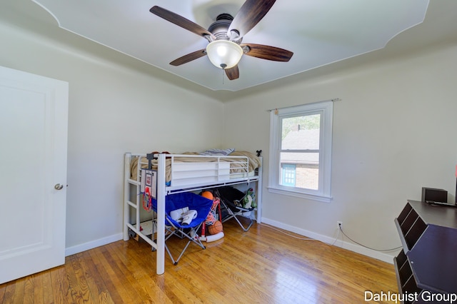 1573 N Whitehall Rd, Muskegon, MI 49445 - bedroom featuring wood finished floors, baseboards, and a ceiling fan