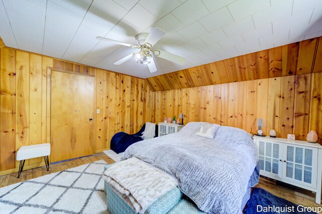 1573 N Whitehall Rd, Muskegon, MI 49445 - bedroom with wood walls, wood finished floors, and ceiling fan