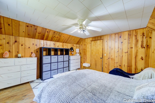 1573 N Whitehall Rd, Muskegon, MI 49445 - bedroom with wooden walls, light wood-style floors, ceiling fan, and lofted ceiling