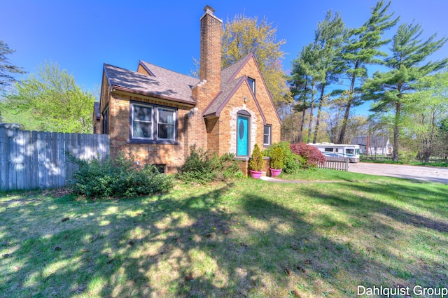 1573 N Whitehall Rd, Muskegon, MI 49445 - tudor-style house featuring brick siding and a chimney