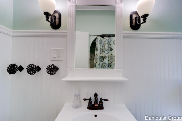 1573 N Whitehall Rd, Muskegon, MI 49445 - bathroom featuring a sink and a wainscoted wall