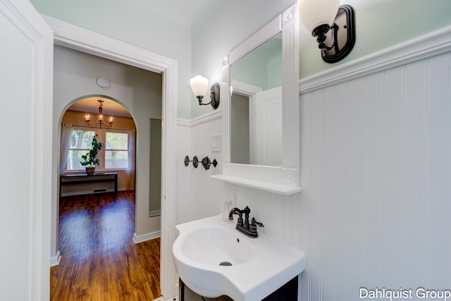 1573 N Whitehall Rd, Muskegon, MI 49445 - bathroom featuring wood finished floors, a chandelier, and vanity