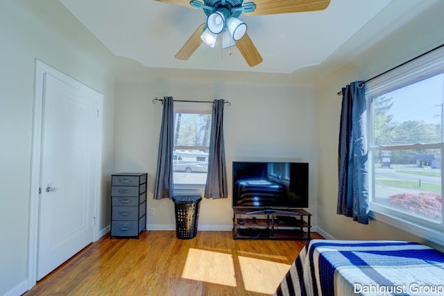 1573 N Whitehall Rd, Muskegon, MI 49445 - bedroom with wood finished floors, baseboards, and a ceiling fan