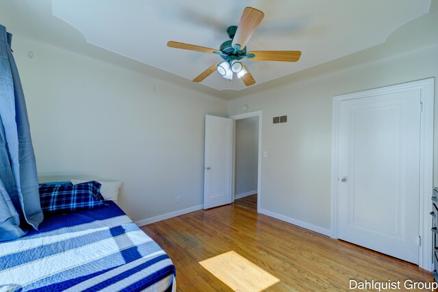 1573 N Whitehall Rd, Muskegon, MI 49445 - unfurnished bedroom with wood finished floors, baseboards, and ceiling fan