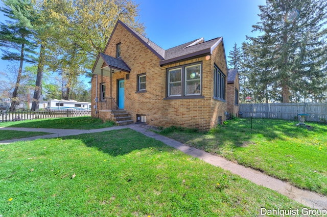 1573 N Whitehall Rd, Muskegon, MI 49445 - bungalow-style home with brick siding and roof with shingles