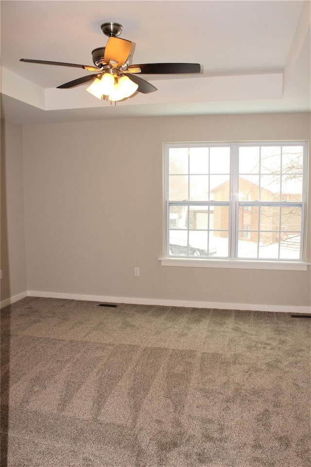 00 High Slope Dr, Brighton, MI 48114 - carpeted empty room with a tray ceiling, ceiling fan, and baseboards