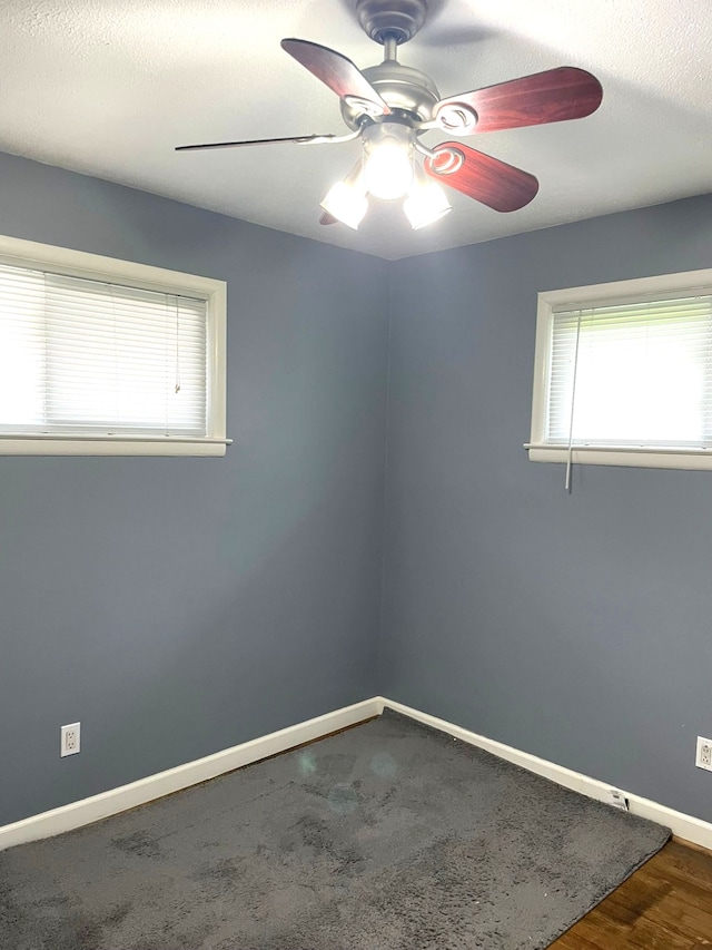 spare room with ceiling fan and baseboards