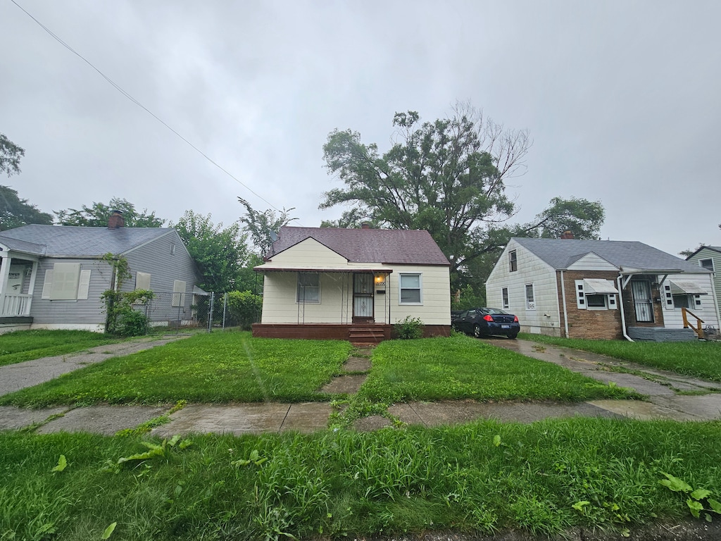 19700 Binder St, Detroit, MI 48234 - bungalow-style house with a front lawn and a porch