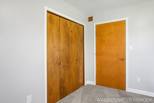 11774 Tyler St, Holland, MI 49424 - unfurnished bedroom featuring carpet, a closet, and baseboards