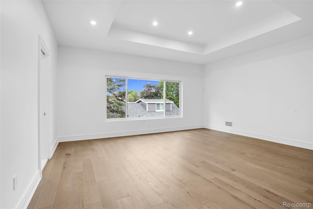 227 W Houstonia Ave, Royal Oak, MI 48073 - unfurnished room with a raised ceiling, light wood-style flooring, recessed lighting, and baseboards
