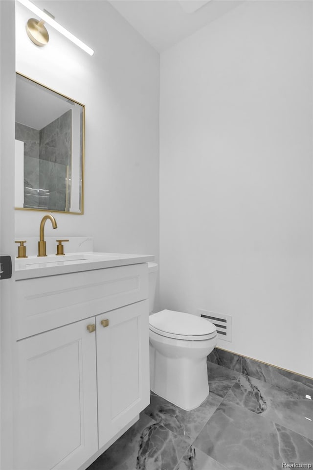 227 W Houstonia Ave, Royal Oak, MI 48073 - full bath featuring marble finish floors, vanity, toilet, and a shower