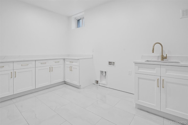 227 W Houstonia Ave, Royal Oak, MI 48073 - washroom featuring cabinet space, washer hookup, and light marble finish floors