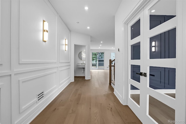 227 W Houstonia Ave, Royal Oak, MI 48073 - hall featuring wood finished floors, an upstairs landing, recessed lighting, and a sink