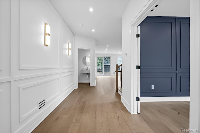227 W Houstonia Ave, Royal Oak, MI 48073 - corridor featuring light wood finished floors, a decorative wall, and recessed lighting