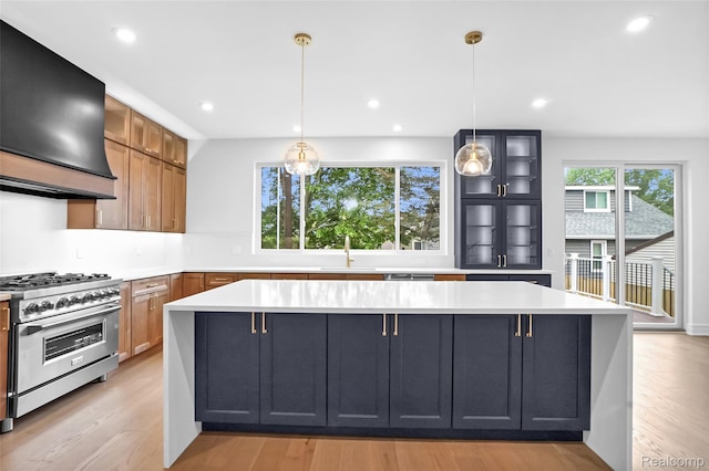 227 W Houstonia Ave, Royal Oak, MI 48073 - kitchen with high end stainless steel range oven, custom range hood, a sink, light countertops, and recessed lighting
