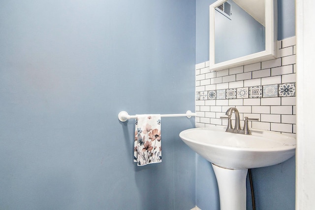 bathroom featuring backsplash and tile walls