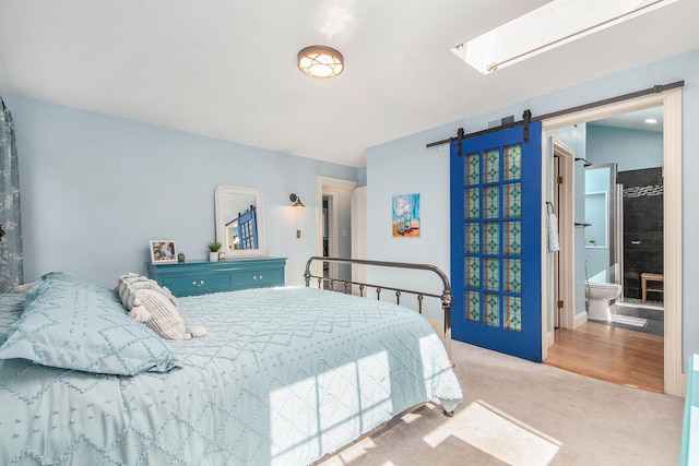 carpeted bedroom featuring a barn door