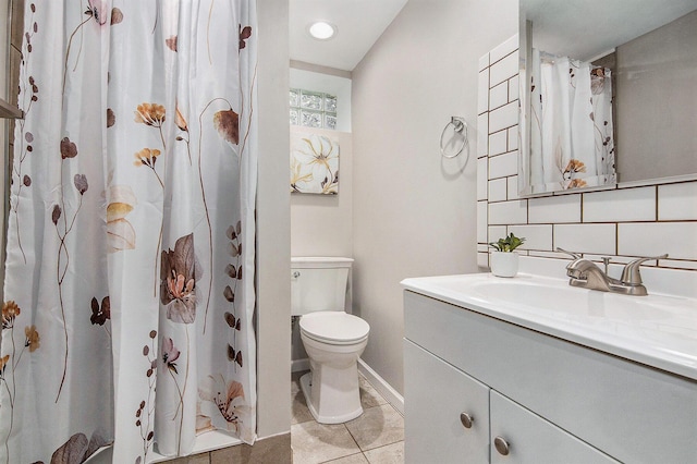full bathroom with vanity, toilet, backsplash, baseboards, and tile patterned floors