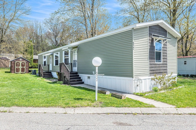 6922 Knotty Pine St NE, Rockford, MI 49341 - manufactured / mobile home featuring a storage shed, an outdoor structure, and a front yard