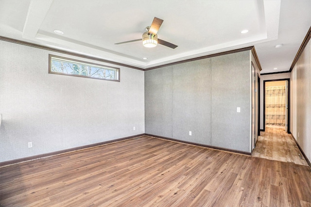 6922 Knotty Pine St NE, Rockford, MI 49341 - unfurnished bedroom with wood finished floors, a raised ceiling, ornamental molding, a ceiling fan, and recessed lighting
